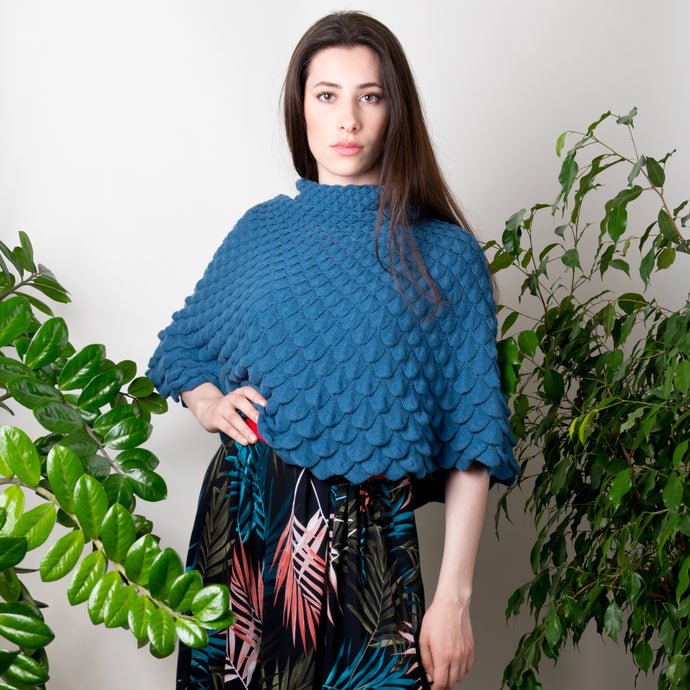 Cape Diana in Farbe Libelle. Wandelbare Strickmode aus Naturmaterialien. Multifunktionelle Maschenmode: Der Poncho, den man auch als Schal, Tuch, Kleid und Rock tragen kann. Hochwertige Materialien und feinste Garne werden zu diesem langlebigen Gestrick in zeitlosem Design verarbeitet. Das Strickmuster ist inspiriert von Motiven der Natur.